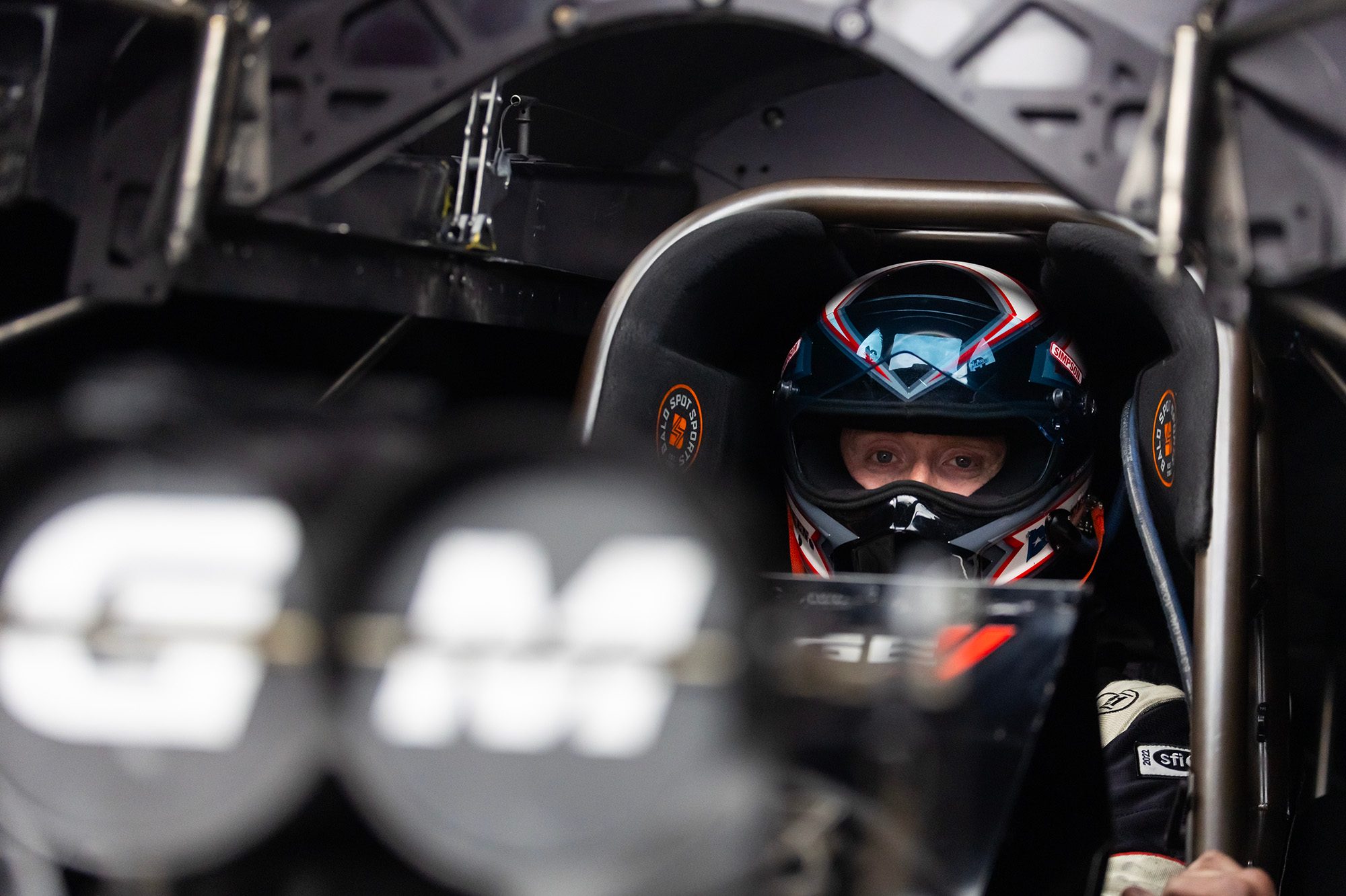 Eyes forward in the cockpit, visor up, before a run