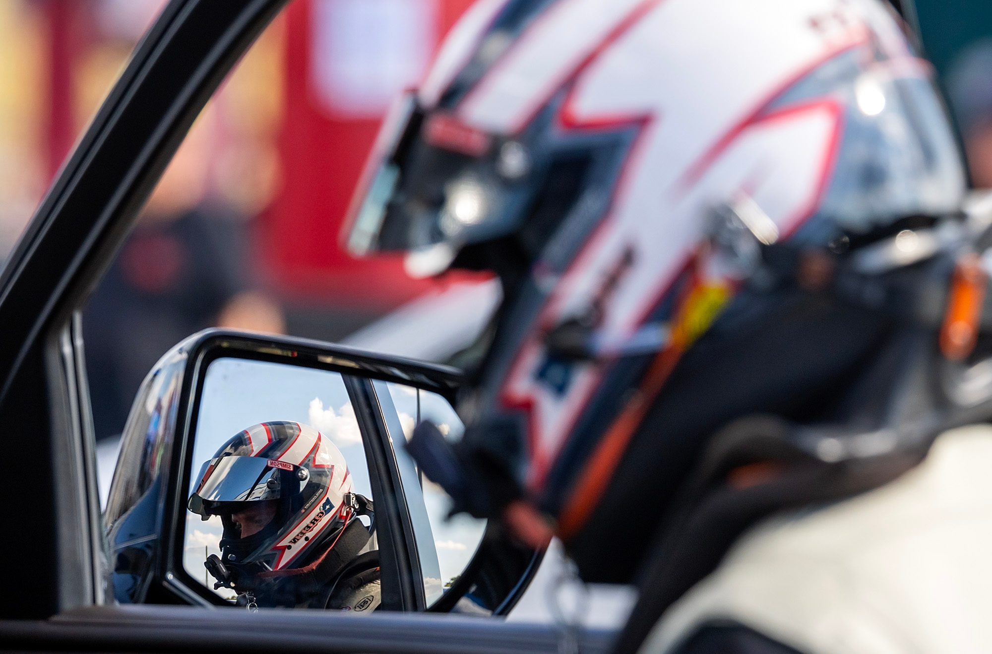 Helmet reflected in the tow vehicle's mirror before the run