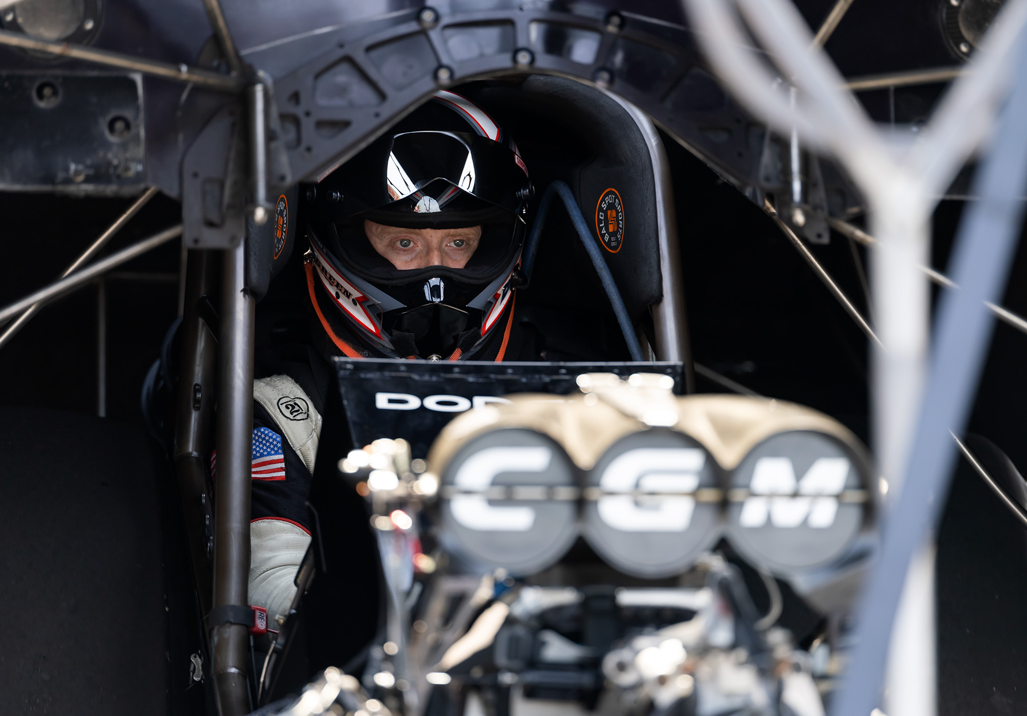 Hunter Green, helmet on, in the cockpit behind the CGM blower