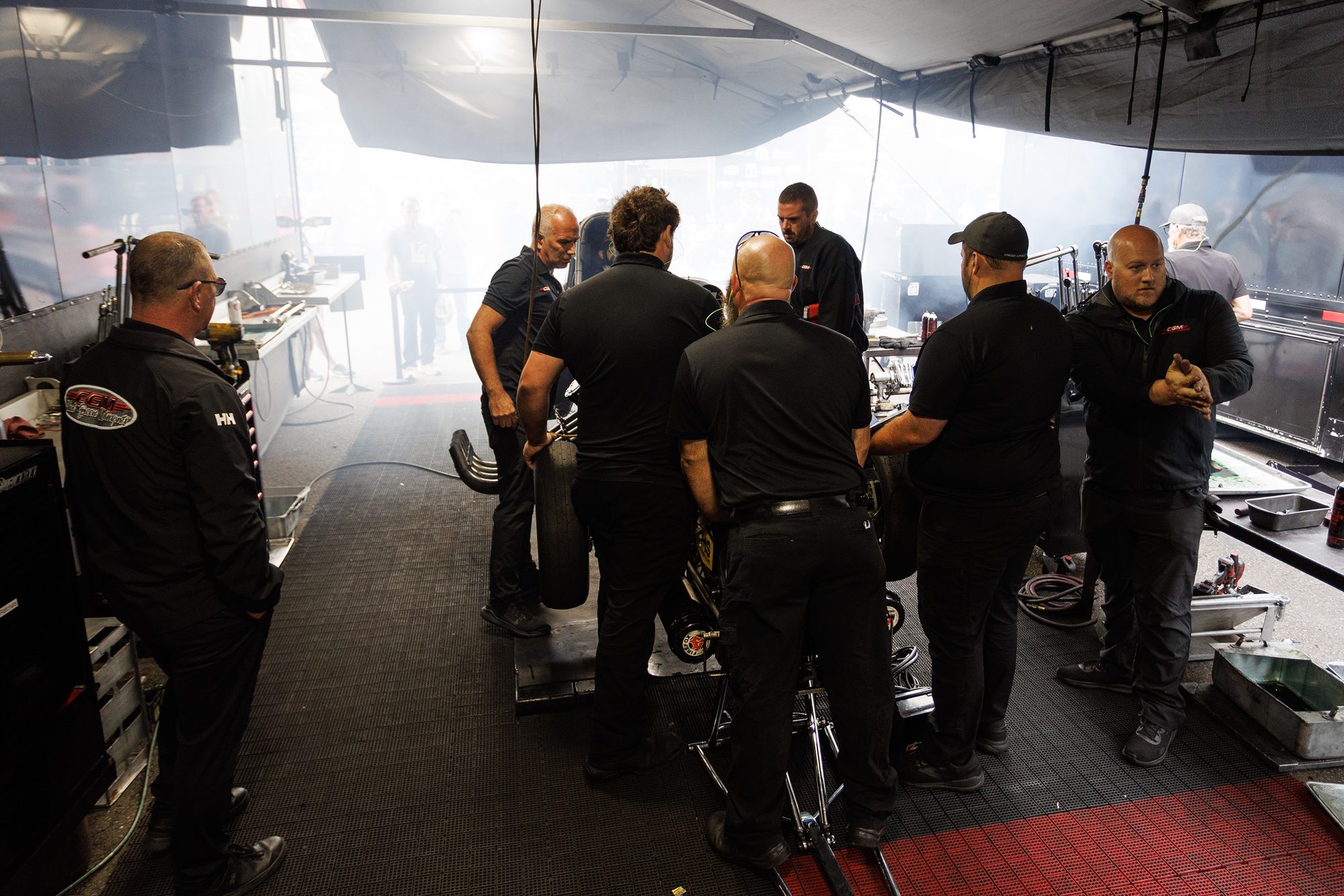Crew huddle under the awning before the warm-up