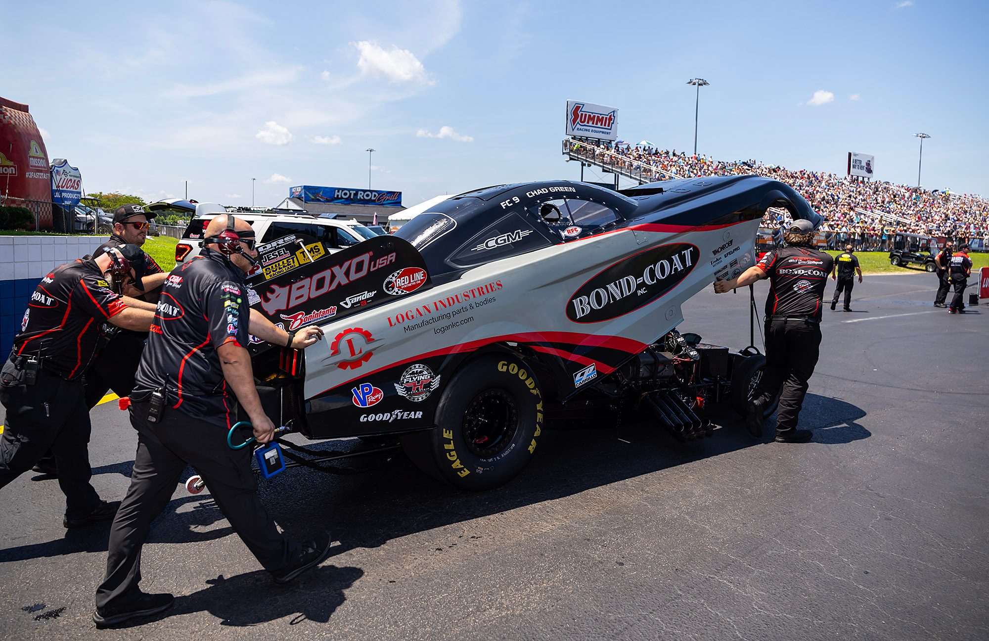 Crew pushes the Bond-Coat Funny Car toward the lanes