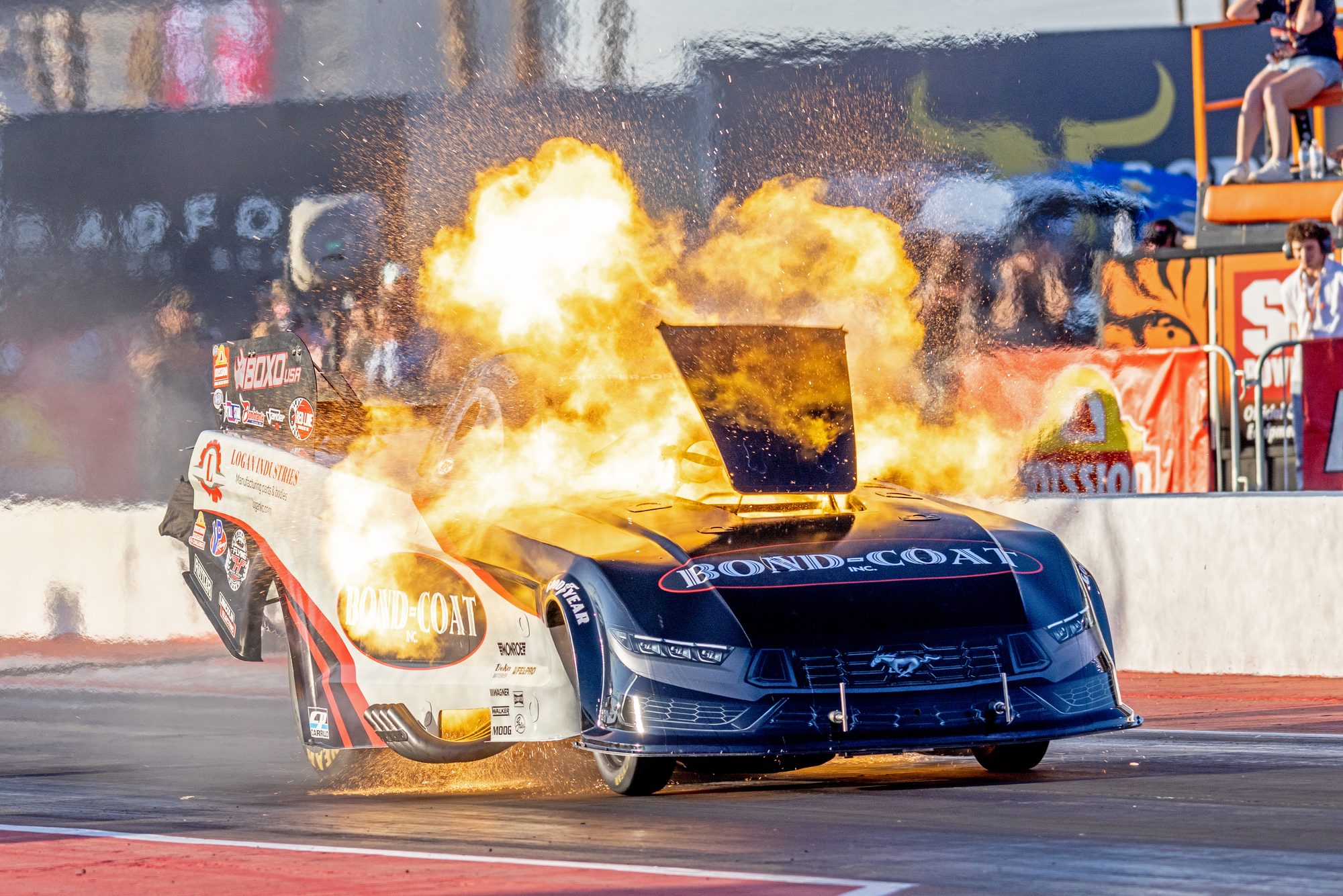 A fireball erupts from the Bond-Coat Funny Car mid-run