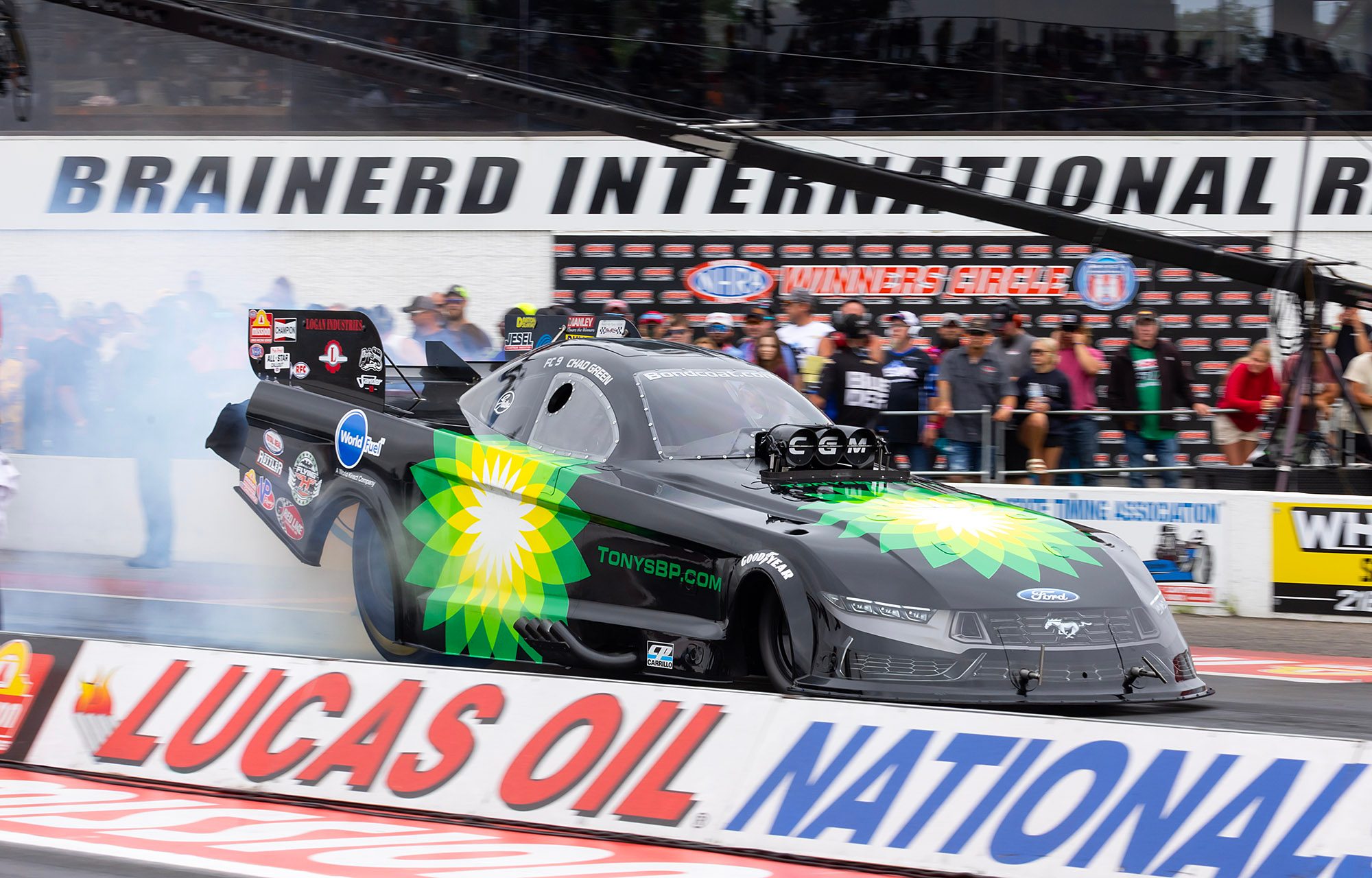 The BP-liveried CGM Funny Car at speed past the Brainerd grandstand