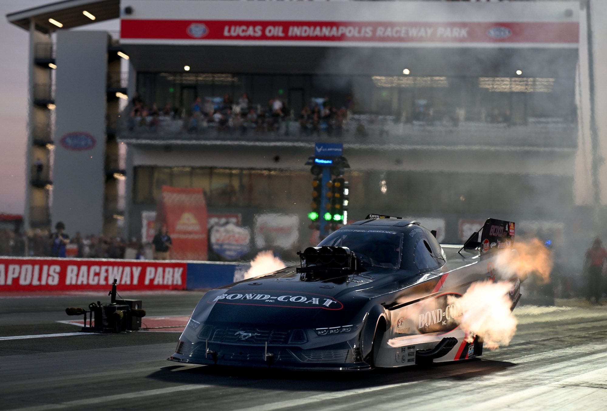 Night session at Indianapolis: header flames on the Bond-Coat Funny Car