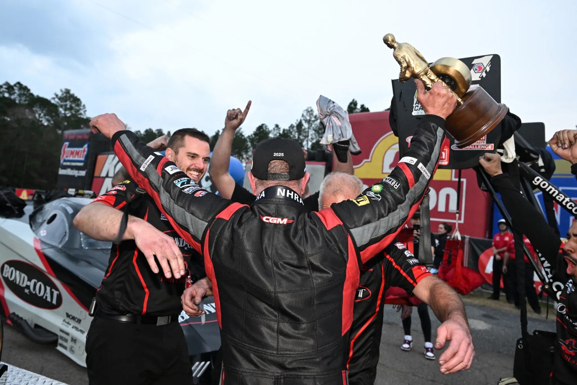 The crew raises the Wally beside the Bond-Coat Funny Car