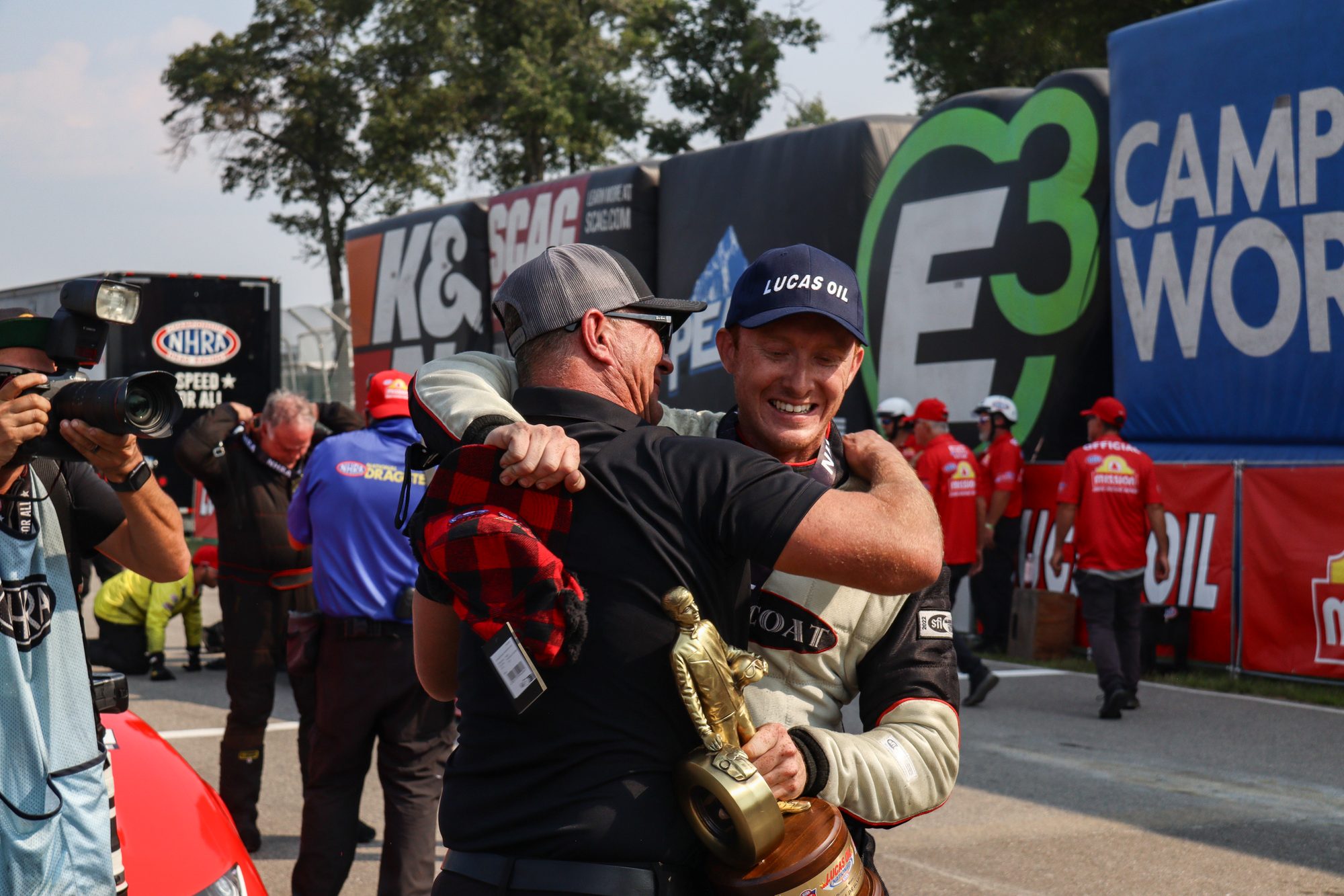 Hunter Green, Wally in hand, hugs a crew member in the winner's circle